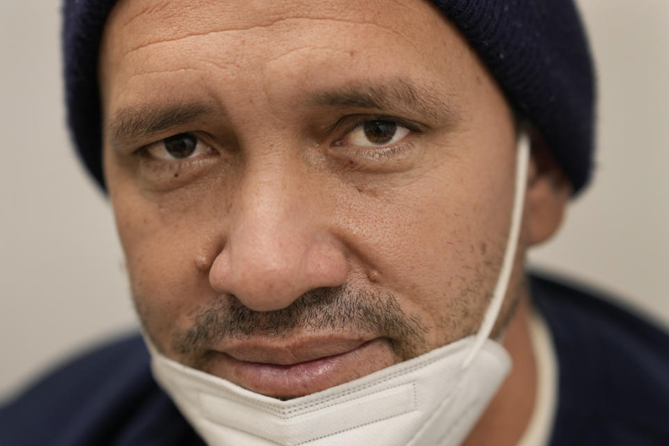 Julio Figuera, 43, sits for a portrait while he waits for medical treatment at the Cook County, Ill., medical clinic on Monday, Oct. 16, 2023, in Chicago. "I rarely get sick," he said. "It was the journey that got me sick." Figuera, developed pneumonia since arriving in the U.S. and has been living with hundreds of other asylum seekers at the airport while awaiting more city permanent shelter. When migrants began arriving in Chicago last year, city leaders tapped the county's health system to take over medical care. (AP Photo/Charles Rex Arbogast)