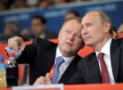 Russian President Vladimir Putin (R) and president of the International Judo Federation (IJF) Marius Vizer chat as they watch the final of the judo competition at the London 2012 Olympic Games, Britain, August 2, 2012. Sputnik/Kremlin/Alexei Druzhinin/via REUTERS