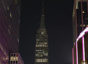 <p>The Empire State Building lights, normally lit in colors, are dimmed Monday, Oct. 2, 2017, in New York, in sympathy for the victims of the mass shooting in Las Vegas. (Photo: Kathy Willens/AP) </p>