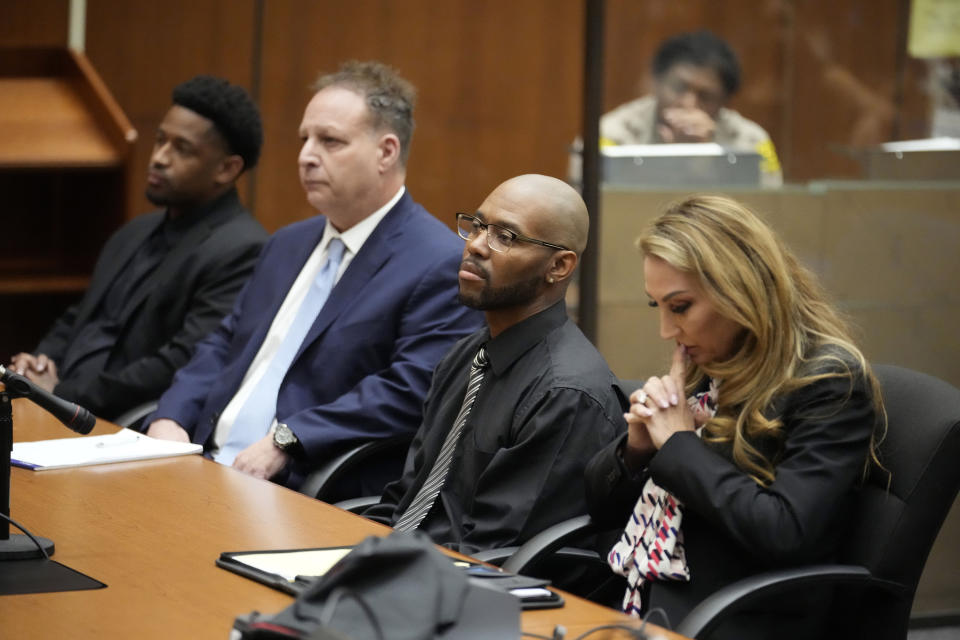 Juan Rayford, second from right, and Dupree Glass, far left, sit with their attorneys Eric Dubin, second from left, and Annee Della Donna, right, as a judge issues a ruling on their case at the Clara Shortridge Foltz Criminal Justice Center Thursday, April 20, 2023, in Los Angeles. Rayford and Glass were convicted of attempted murder and sentenced to 11 consecutive life sentences. They served 17 years in prison before being released in 2020 after a judge ruled they were wrongfully convicted. (AP Photo/Marcio Jose Sanchez)