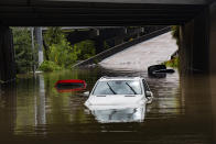 Cars stranded on high flood waters on Houston Ave. exit from Interstate 45 during Tropical Storm Beta Tuesday, Sept. 22, 2020, in Houston. Beta has weakened to a tropical depression as it parked itself over the Texas coast, raising concerns of extensive flooding in Houston and areas further inland. (Marie D. De Jesus/Houston Chronicle via AP)