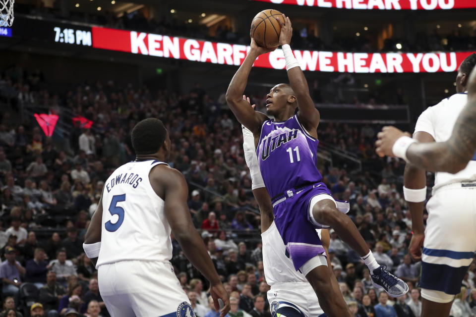 Utah Jazz guard Kris Dunn (11) drives to shoot while Minnesota Timberwolves guard Anthony Edwards (5) defends during the first half of an NBA basketball game Monday, March 18, 2024, in Salt Lake City. (AP Photo/Adam Fondren)