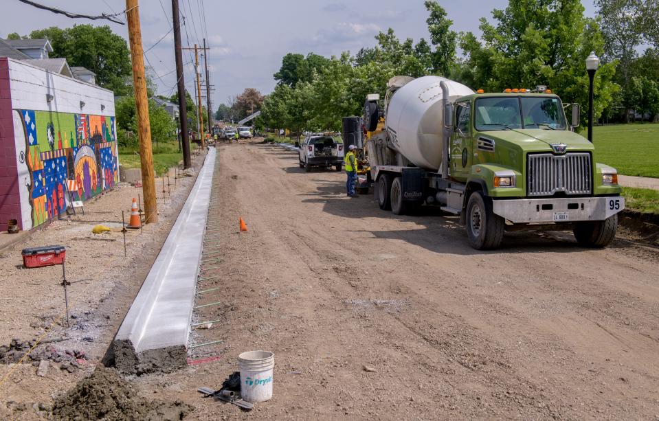 Workers build curbs along Wisconsin Avenue as part of a large reconstruction of the busy thoroughfare in Peoria's East Bluff.