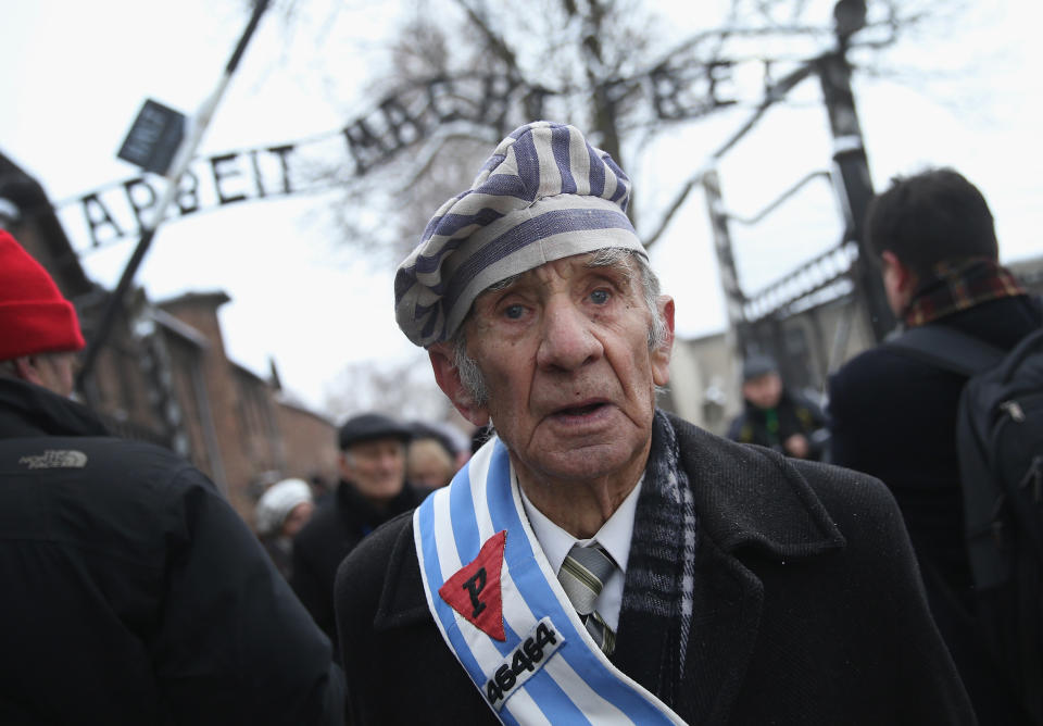 A member of an association of Auschwitz concentration camp survivors walks through the infamous 'Arbeit Macht Frei' entrance gate after laying wreaths with other members at the execution wall at the former Auschwitz I concentration camp on January 27, 2015 in Oswiecim, Poland. International heads of state, dignitaries and over 300 Auschwitz survivors are attending the commemorations for the 70th anniversary of the liberation of Auschwitz by Soviet troops on 27th January, 1945. Auschwitz was among the most notorious of the concentration camps run by the Nazis during WWII and whilst it is impossible to put an exact figure on the death toll it is alleged that over a million people lost their lives in the camp, the majority of whom were Jewish.