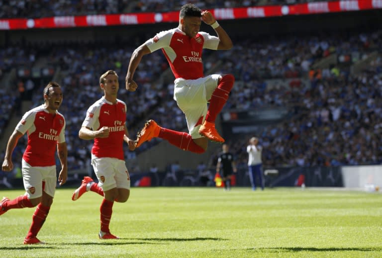 Arsenal's English midfielder Alex Oxlade-Chamberlain (R) celebrates scoring the opening goal of the FA Community Shield football match between Arsenal and Chelsea at Wembley Stadium in north London on August 2, 2015