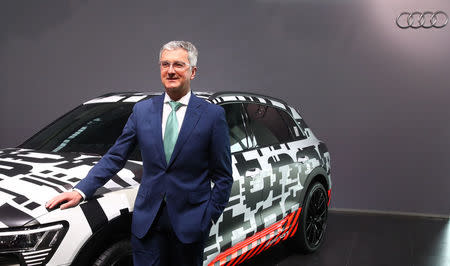 Audi CEO Rupert Stadler poses next to the Audi Q7 e-tron quatro car before the company's annual news conference in Ingolstadt, Germany March 15, 2018. REUTERS/Michael Dalder