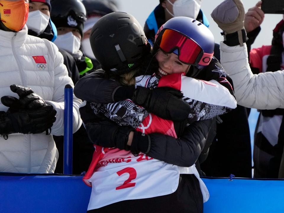 Eileen Gu (right) hugs Chloe Kim after her gold-medal performance in Beijing.