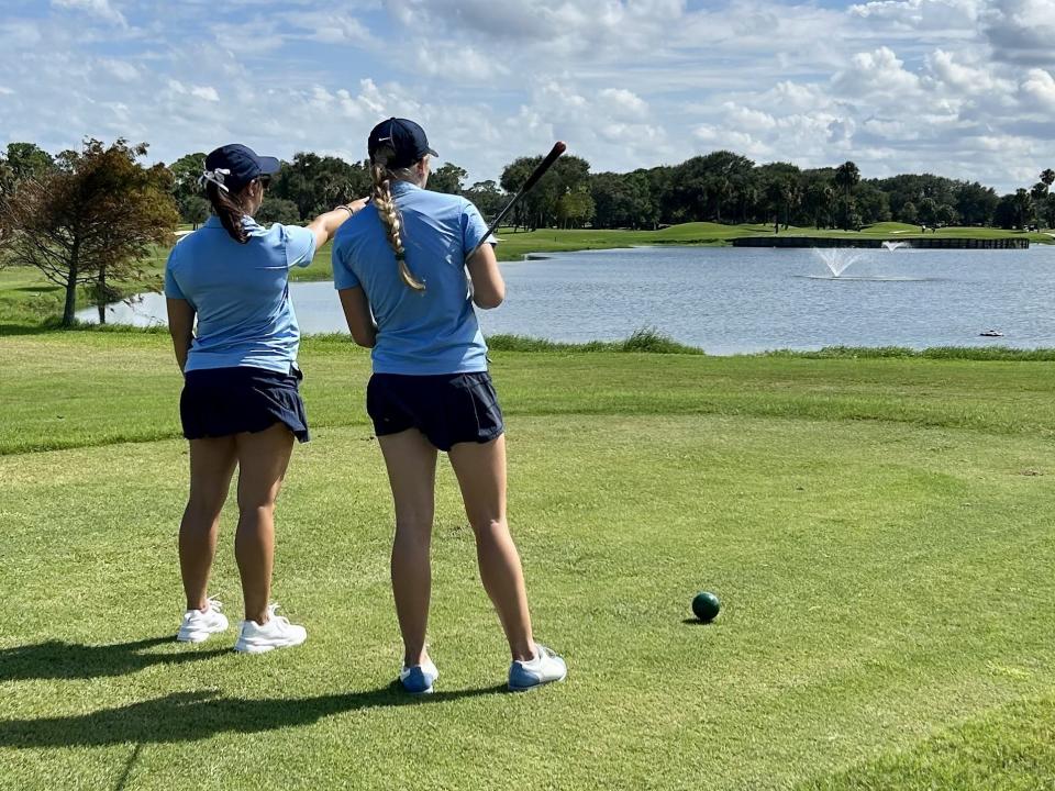 St. Johns Country Day golf coach Mindy Herrick goes over the tee shot at the par-5 13th hole of the Jacksonville Beach Golf Club with Addy Vogt during Saturday's Jacksonville Beach Varsity Invitational.
