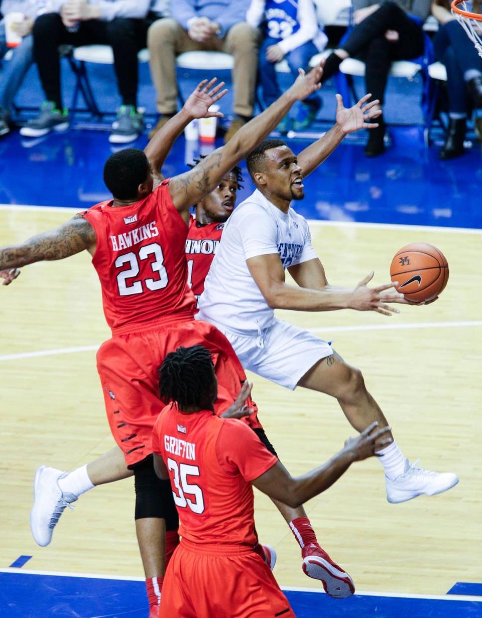 Kentucky guard Isaiah Briscoe (13) sliced inside Illinois State Redbirds forward Deontae Hawkins (23) for a basket in UK’s 75-63 victory over the Redbirds at Rupp Arena on Nov. 30, 2015. Briscoe led the Wildcats in scoring in the game with 18 points.