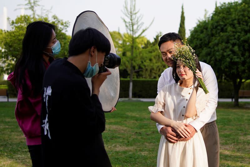 Peng Jing, 24, and Yao Bin, 28, pose for their wedding photography shoot after the lockdown was lifted in Wuhan
