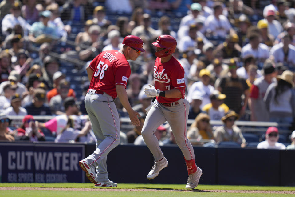 Cincinnati Reds' Spencer Steer, right, is greeted by third base coach J.R. House after hitting a home run during the sixth inning of a baseball game against the San Diego Padres, Wednesday, May 3, 2023, in San Diego. (AP Photo/Gregory Bull)