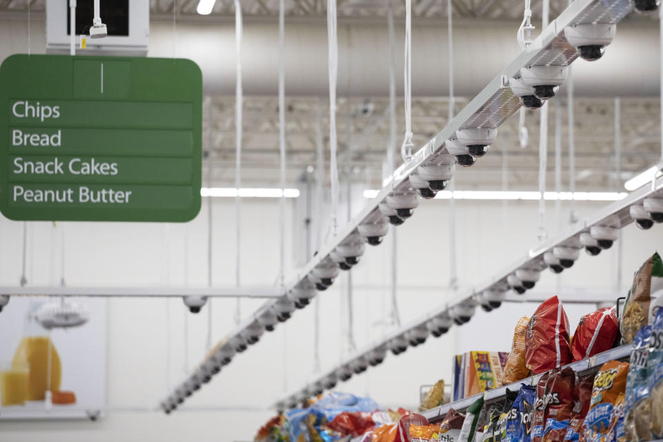Dozens of cameras hang above an aisle at a Walmart Neighborhood Market, Wednesday, April 24, 2019, in Levittown, N.Y. This living lab, dubbed Walmart's Intelligent Retail Lab, is Walmart's biggest attempt to digitize the physical store. (AP Photo/Mark Lennihan)