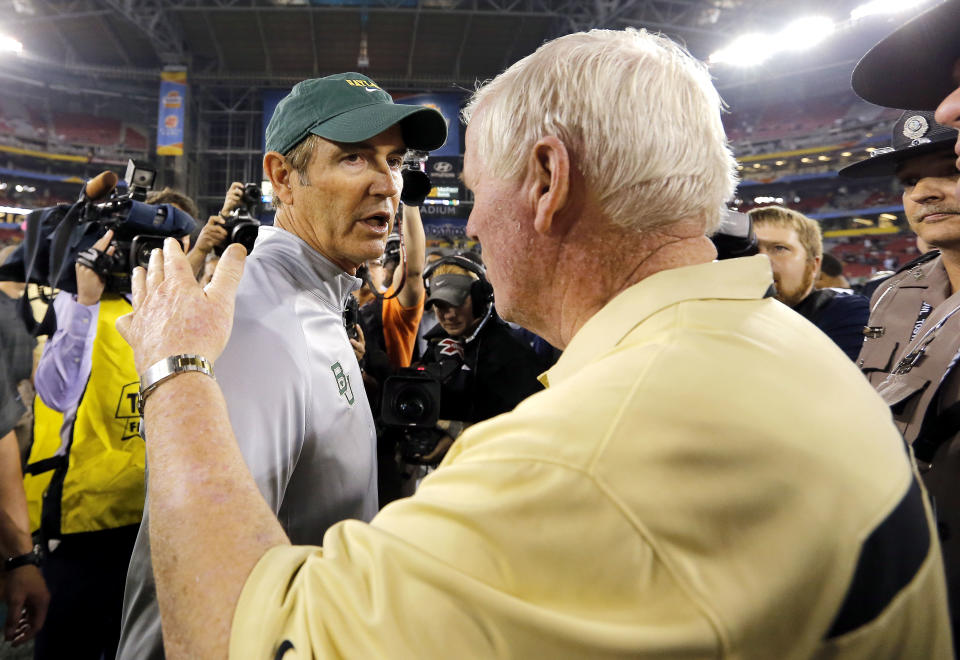 Central Florida head coach George O'Leary, right, greets Baylor head coach Art Briles at mid-field after the Fiesta Bowl NCAA college football game against Baylor, Wednesday, Jan. 1, 2014, in Glendale, Ariz. Central Florida won 52-42. (AP Photo/Matt York)