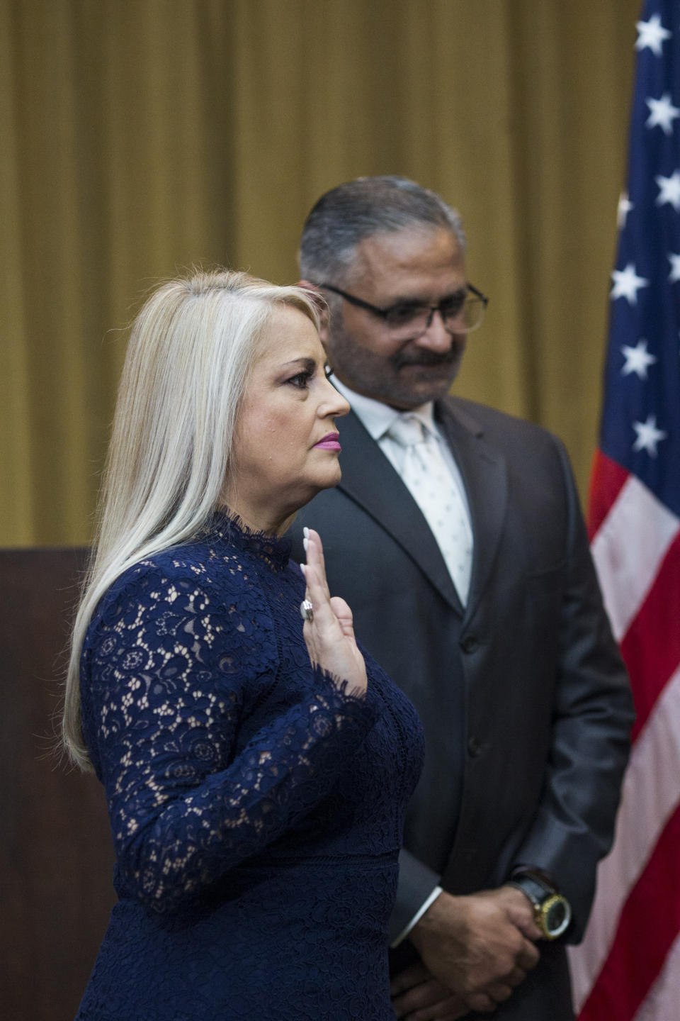 Justice Secretary Wanda Vazquez is sworn in as governor, accompanied by her husband Judge Jorge Diaz, in San Juan, Puerto Rico, Wednesday, Aug. 7, 2019. Vazquez took the oath of office early Wednesday evening at the Puerto Rican Supreme Court, which earlier in the day ruled that Pedro Pierluisi's swearing in last week was unconstitutional. (AP Photo/Dennis M. Rivera Pichardo)