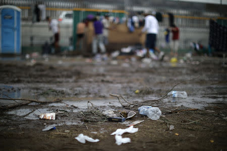 Trash lies in the mud next to showers in a temporary shelter for a caravan of thousands of migrants from Central America trying to reach the United States, in Tijuana, Mexico, November 28, 2018. REUTERS/Lucy Nicholson