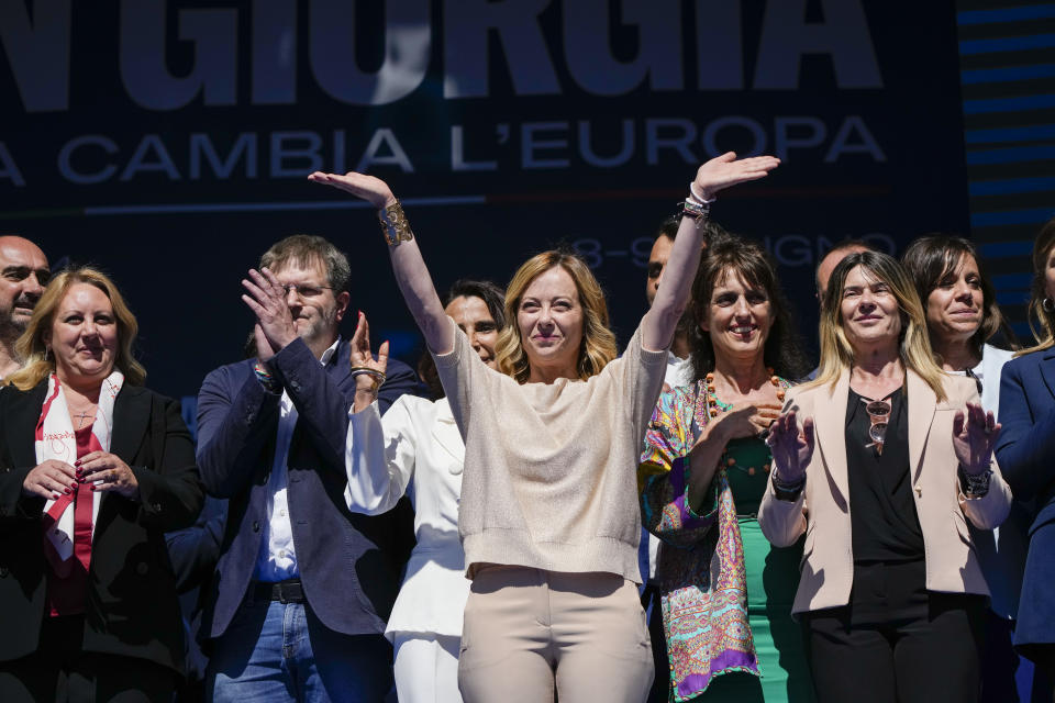 Italian Premier Giorgia Meloni, center, and Brothers of Italy fellow party members and candidates wave from the stage during an electoral rally ahead of the EU parliamentary elections that will take place in Italy on 8 and 9 June, in Rome, Saturday, June 1, 2024. (AP Photo/Alessandra Tarantino)