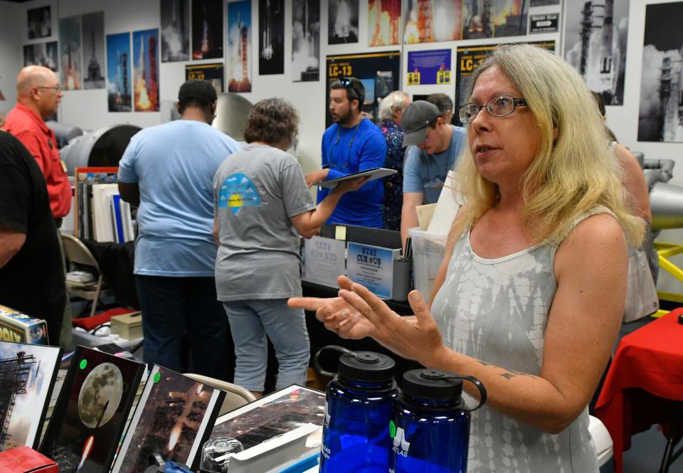 Julia Bergeron, a Sands Space History Center docent, chats from behind a vendor table during the U.S. Space Force Historical Foundation collectibles event.