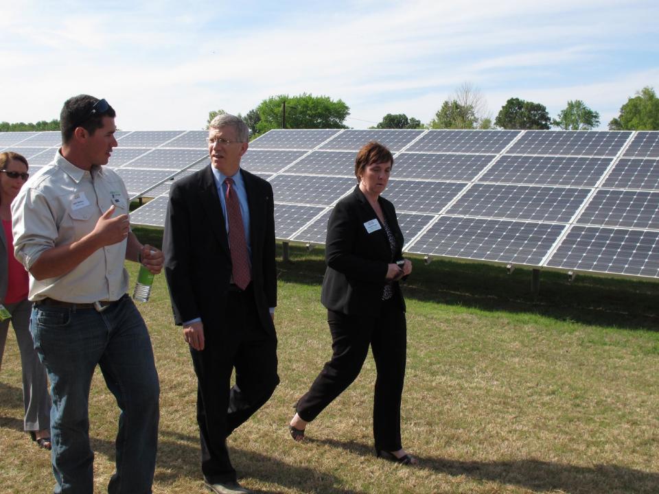 In a Thursday, April 12, 2012 photo, Daniel Poneman, the deputy secretary for the U.S. Department of Energy, center, is given a tour of the West Tennessee Solar Farm by two project managers in Stanton, Tenn. Hundreds of industry members gathered this week in Memphis for a solar energy symposium and the dedication of a 1 megawatt solar farm. Industry leaders also met in Stanton, where Tennessee's largest solar generating facility uses its more than 21,000 panels to harness the sun's energy to output 5 megawatts of power. (AP Photo/Adrian Sainz)