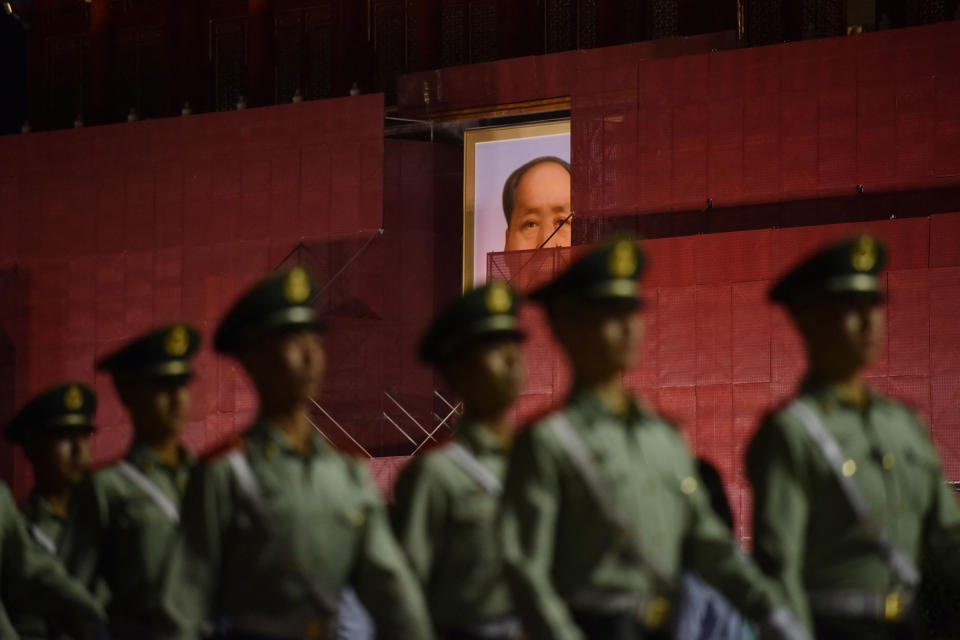 Paramilitary police officers march past a portrait of Mao Zedong on Tiananmen Gate, in Beijing, on May 19, 2019. <span class="copyright">Greg Baker—/AFP/Getty Images</span>