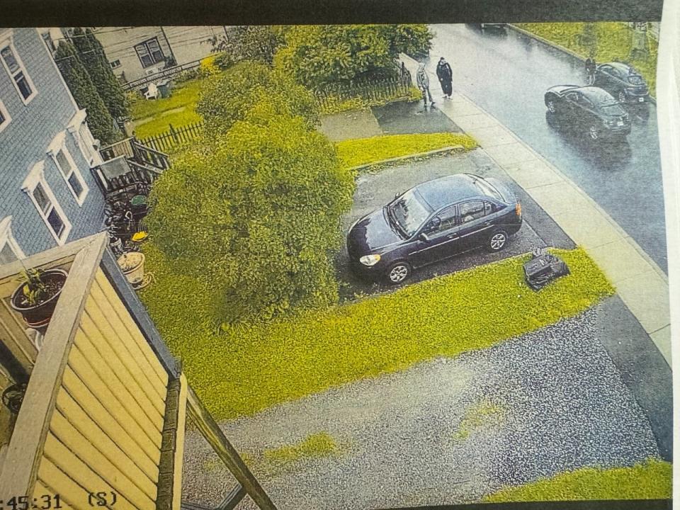 Charles Shatford is seen standing on the sidewalk, dressed in black, outside the home of Donald Walker at 3:45 p.m. on Aug. 17, 2022, in this image taken from security video. 