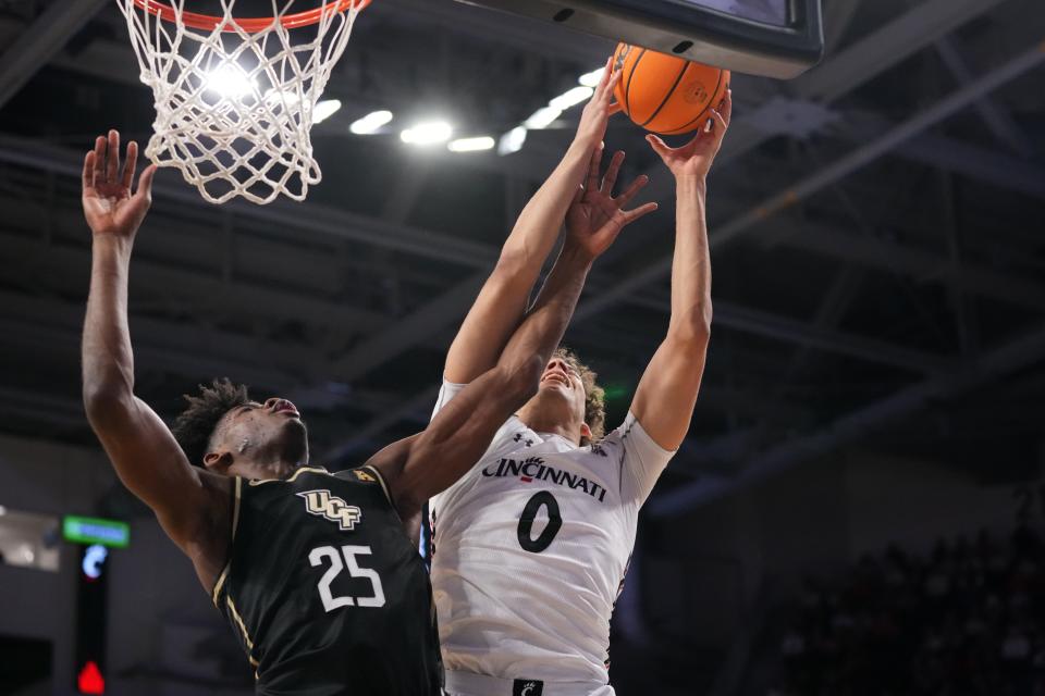 Cincinnati Bearcats guard Dan Skillings Jr. (0) rebounds the ball away from UCF Knights forward Taylor Hendricks (25) in the first half of a college basketball game between the UCF Knights and the Cincinnati Bearcats, Saturday, Feb. 4, 2023, at Fifth Third Arena. Skillings has added several pounds and has increased his vertical leap as he enters the 2023-24 season.