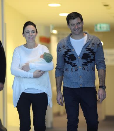 New Zealand Prime Minister Jacinda Ardern carries her newborn baby Neve Te Aroha Ardern Gayford with partner Clarke Gayford as she walks out of the Auckland Hospital in New Zealand, June 24, 2018. REUTERS/Ross Land