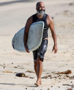 <p>Jeffrey Wright goes surfing in Hawaii on Monday.</p>