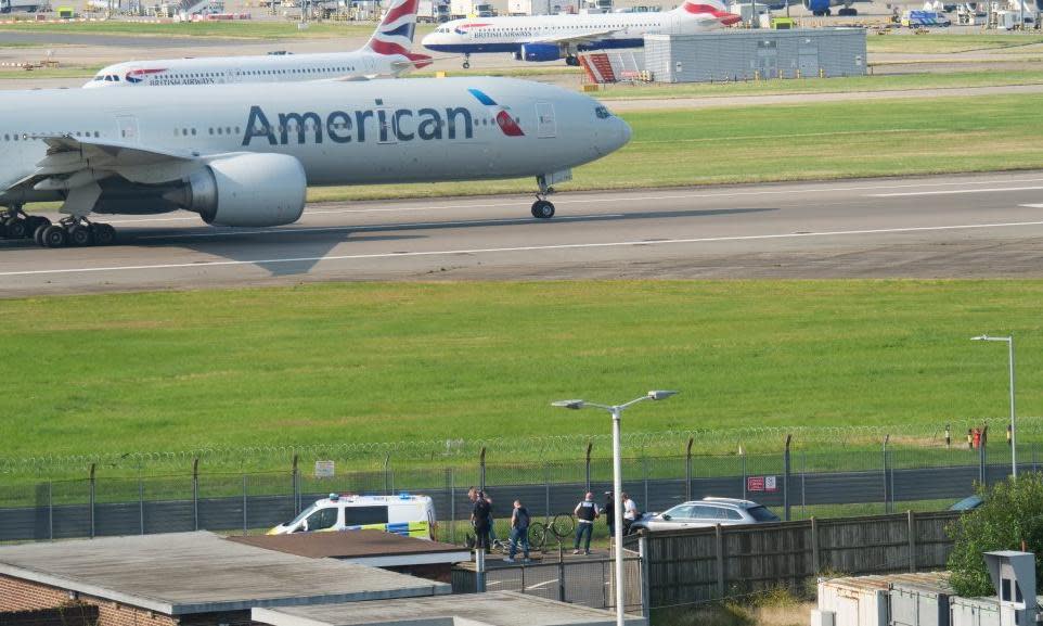 <span>Police officers carrying out arrests at Heathrow airport perimeter on Wednesday.</span><span>Photograph: Anadolu/Getty Images</span>