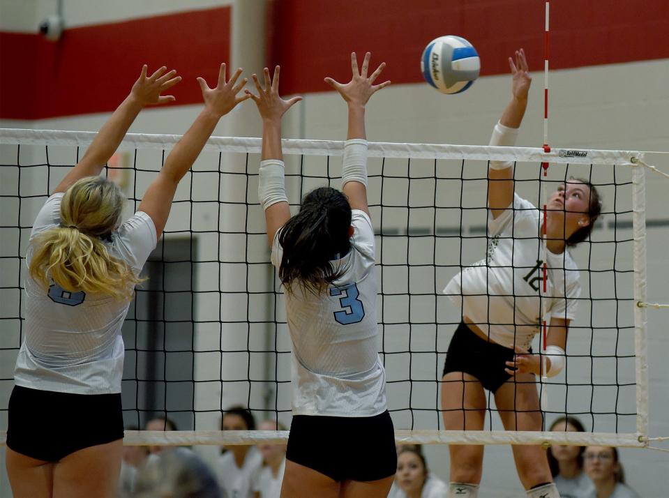Jessica Costlow of SMCC goes up to spike pass  Riley Howe and Caitlin OÕNeill of Skyline in the Bedford volleyball tournament Friday, September 1, 2023. 