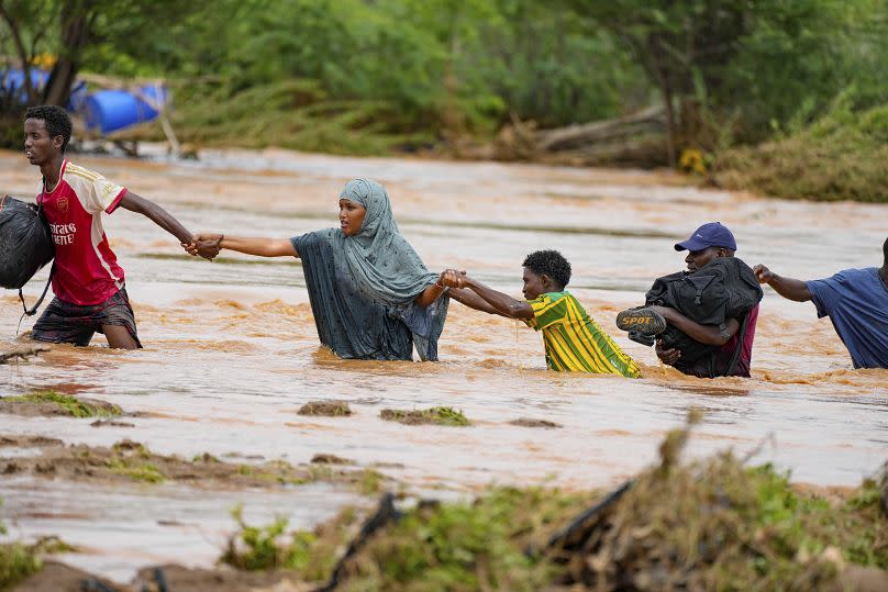 Residents cross a road damaged by El Niño rains in Tula, Tana River county in Kenya in November.