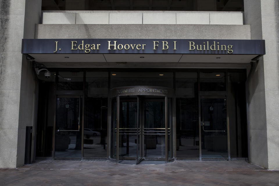 FILE - In this March 4, 2019, file photo, the J. Edgar Hoover FBI Building is seen in Washington. The FBI, in a change of policy, is committing to inform state officials if local election systems have been breached, federal officials told The Associated Press. (AP Photo/Alex Brandon, File)