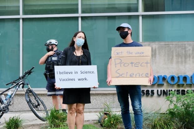 Vaccine supporters gather in response to anti-vax protesters who met at Queen's Park, and later en route to and in front of Toronto General Hospital. (Patrick Morrell/CBC - image credit)