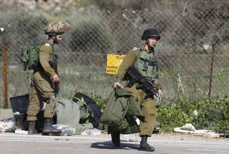 Israeli soldiers walk near Israel's border with Lebanon January 28, 2015. REUTERS/Baz Ratner