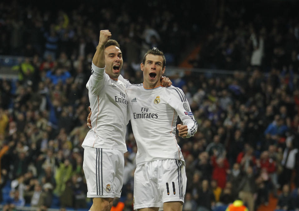 Real's Gareth Bale celebrates scoring the opening goal with Real's Daniel Carvajal, left, during a Champions League quarterfinal first leg soccer match between Real Madrid and Borussia Dortmund at the Santiago Bernabeu stadium in Madrid, Spain, Wednesday April 2, 2014. (AP Photo/Paul White)