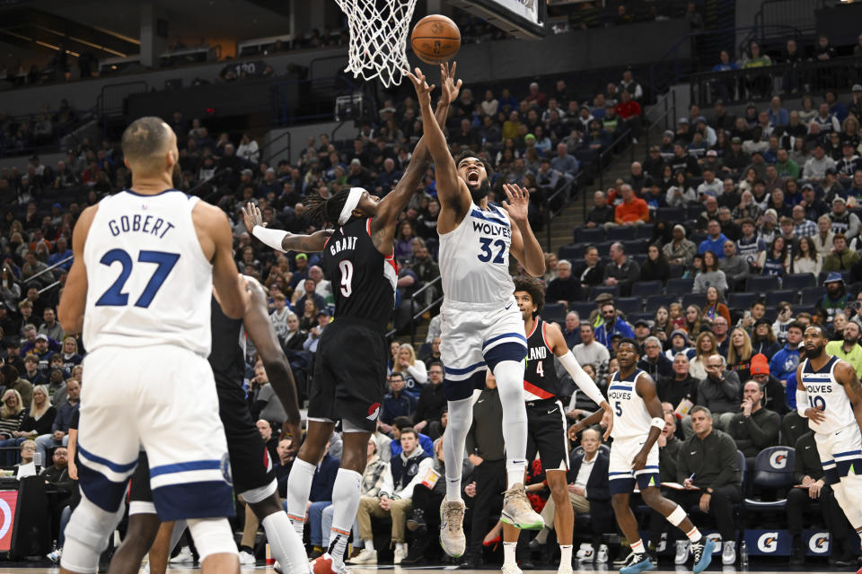 A shot by Minnesota Timberwolves center Karl-Anthony Towns (32) is blocked by Portland Trail Blazers forward Jerami Grant during the first half of an NBA basketball game Friday, Jan. 12, 2024, in Minneapolis. (AP Photo/Craig Lassig)