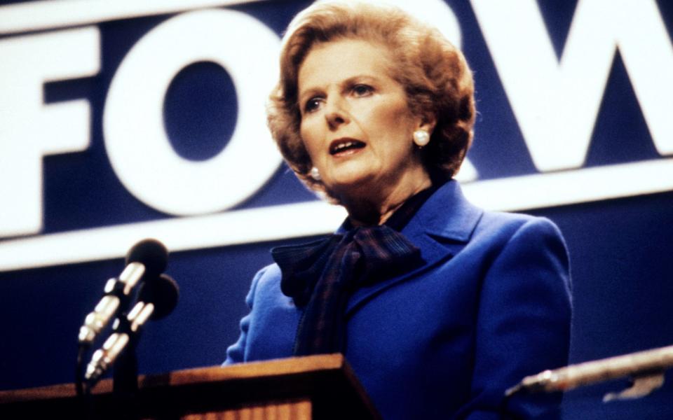 Margaret Thatcher addressing the Tory conference in party colours - PA