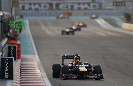 Red Bull Formula One driver Sebastian Vettel of Germany drives during the Abu Dhabi F1 Grand Prix at the Yas Marina circuit on Yas Island, November 3, 2013. REUTERS/Steve Crisp