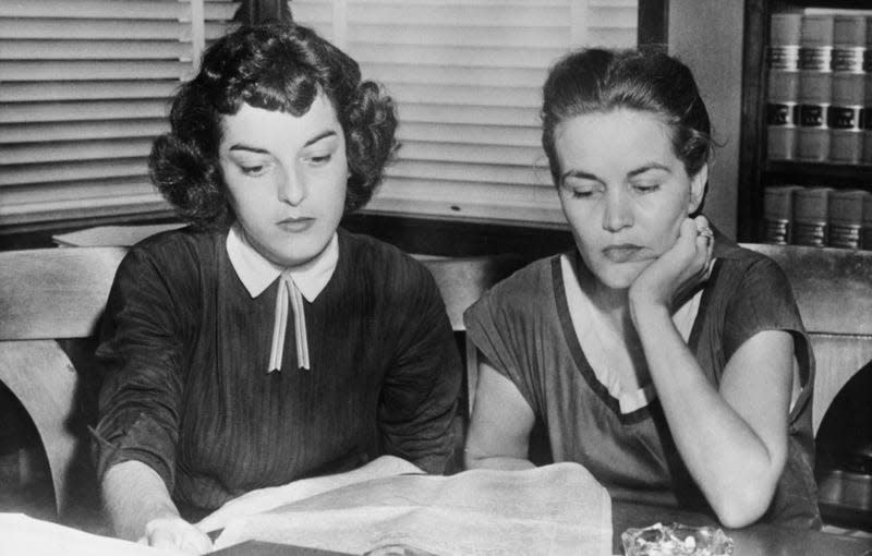 Carolyn Bryant and Juanita Milam (1927-2014), the wives of Roy Bryant and John William Milam, who stand accused of the kidnap and murder of Emmett Till, sitting in their husbands’ lawyer’s office across the street from the courthouse, reading newspaper accounts of the trial at Sumner courthouse in Sumner, Mississippi, September 1955. Black teenager Emmett Till was alleged to have whistled at Carolyn Bryant. ( - Photo: Bettmann Archive/Getty Images) (Getty Images)