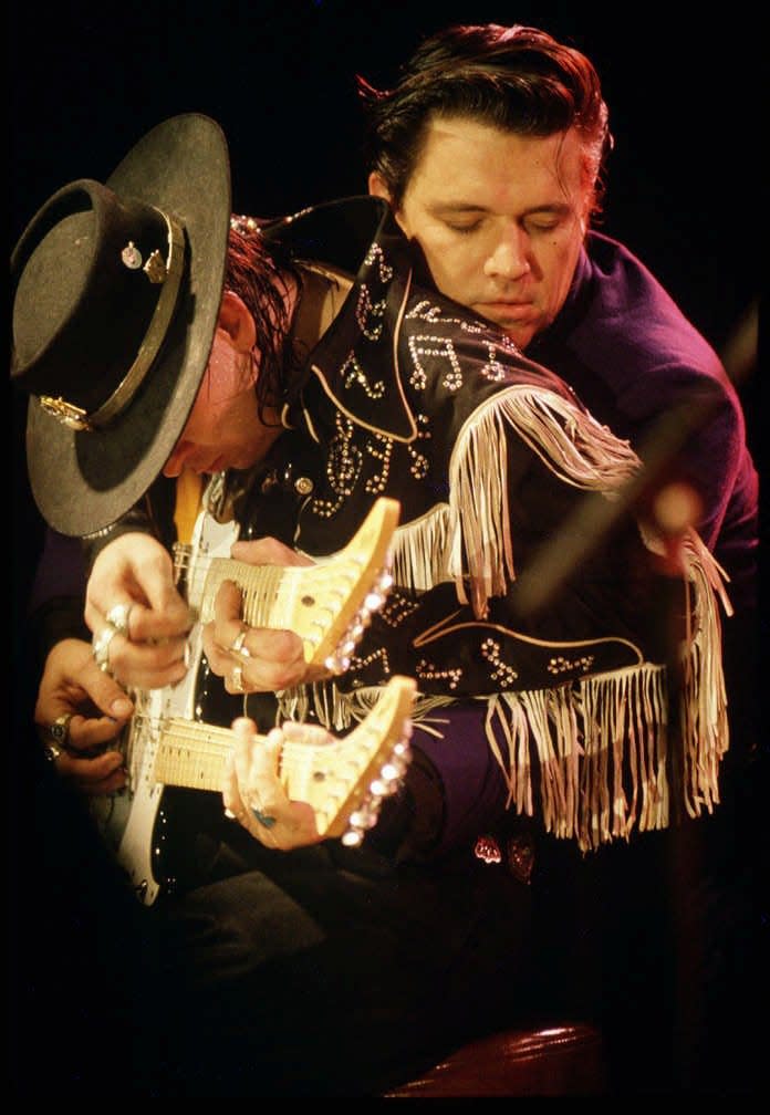 Stevie Ray Vaughan, left, and his brother, Jimmie, perform together during the recording of a live album at the Austin Opera House in 1986.