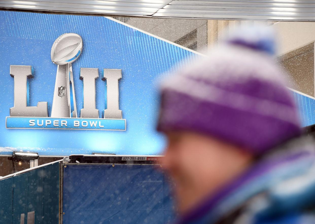 A volunteer stands in the snow during the Super Bowl LIVE, a 10-day fan festival leading up to Super Bowl LII, taking place on Minneapolis Nicollet Mall in Downtown Minneapolis, Minnesota February 3, 2018. (Photo credit should read ANGELA WEISS/AFP via Getty Images)