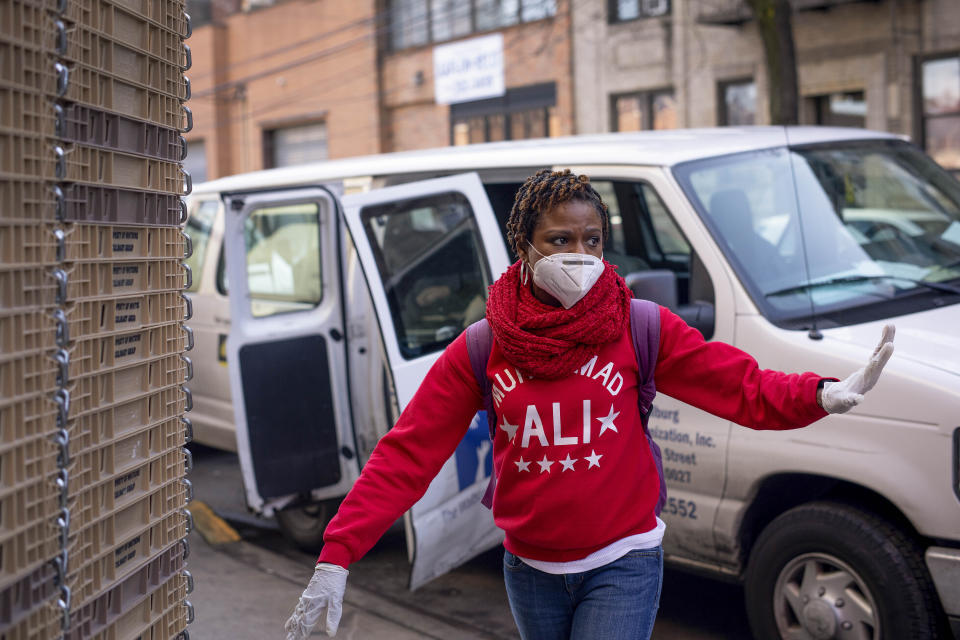 Carla Brown, executive director for the Charles A. Walburg Multiservice Organization arrives to pick up meals from a caterer, Monday, April 6, 2020, in the Queens borough of New York. The coronavirus pandemic has kept loved ones apart, younger family members fearful of bringing the disease to older relatives who may be so much more susceptible. That's driven Brown even more to make sure those elderly are receiving the care they need through her meals-on-wheels program. (AP Photo/Robert Bumsted)