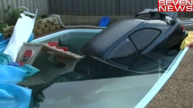 Car in a pool near Macquarie Fields. Photo: 7News