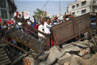 Protesters shout slogans as police arrive during a protest against the military coup in Mandalay, Myanmar, Sunday, Feb. 28, 2021. Police in Myanmar escalated their crackdown on demonstrators against this month's military takeover, deploying early and in force on Saturday as protesters sought to assemble in the country's two biggest cities and elsewhere. (AP Photo)