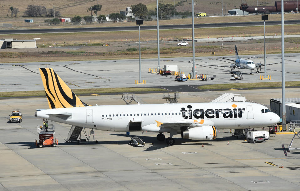 Emergency service crews are seen alongside Tiger Airways flight 511 at Melbourne Airport in Melbourne, Tuesday, March 1, 2016 (AAP Image/Julian Smith)