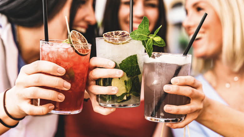 women holding assorted cocktails