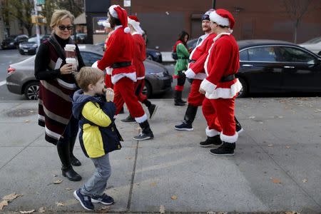 Revelers dressed in Santa Claus and other holiday themed outfits take part in the annual SantaCon event in the Brooklyn borough of New York, December 12, 2015. REUTERS/Brendan McDermid