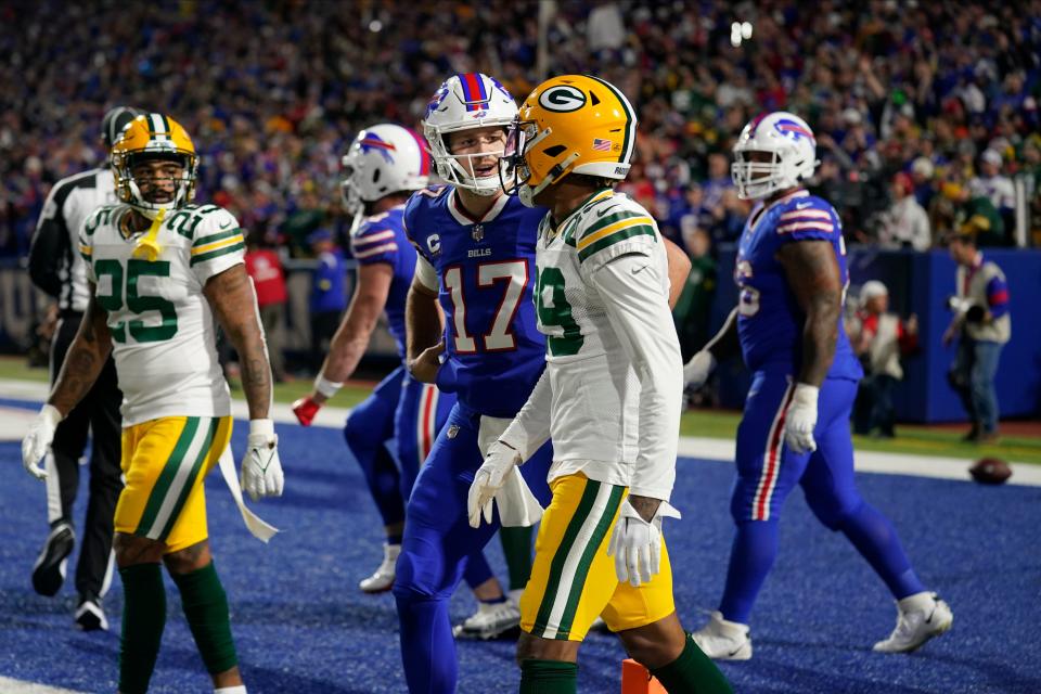 Buffalo Bills quarterback Josh Allen (17) talks to Green Bay Packers cornerback Rasul Douglas (29) after throwing a touchdown pass during the first half of an NFL football game Sunday, Oct. 30, 2022, in Orchard Park. (AP Photo/Seth Wenig)