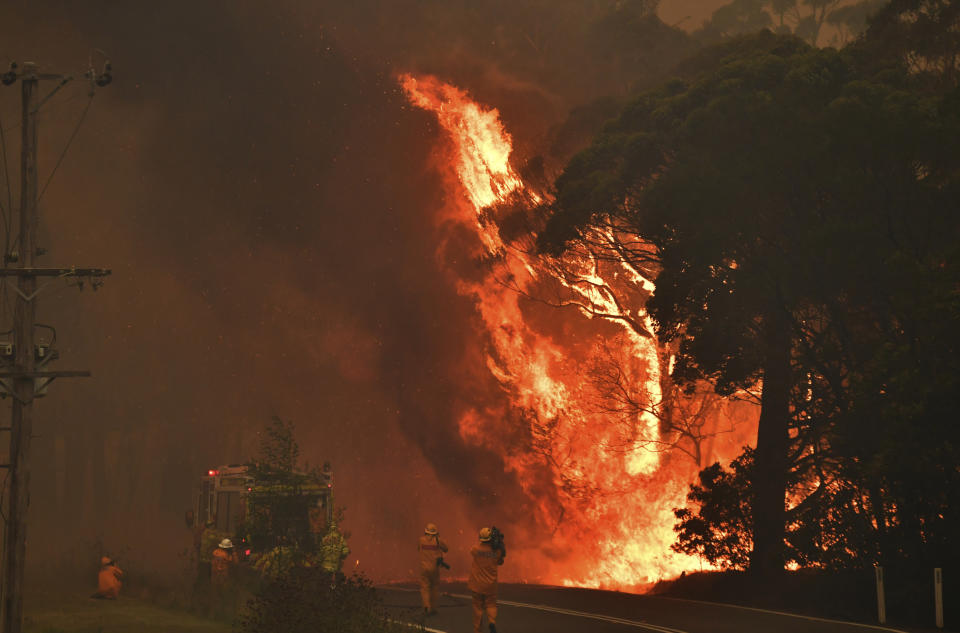 A fire truck is seen during a bushfire near Bilpin, 90 kilometers (56 miles) northwest of Sydney, Thursday, Dec. 19, 2019. Australia's most populous state of New South Wales declared a seven-day state of emergency Thursday as oppressive conditions fanned around 100 wildfires. (Mick Tsikas/AAP Images via AP)