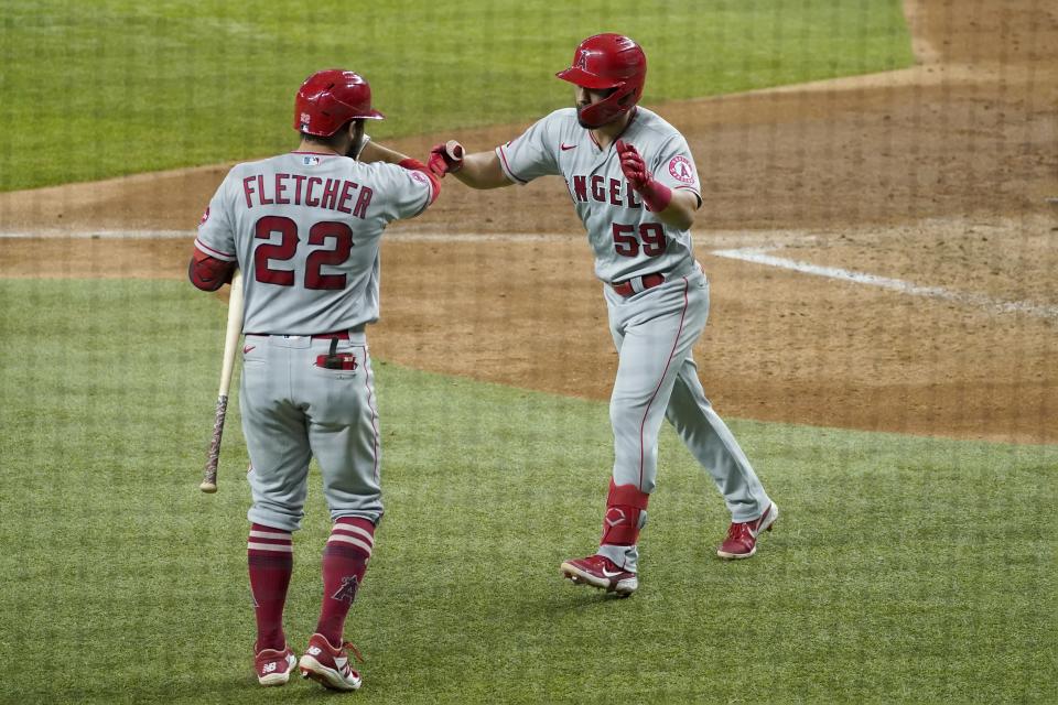 Los Angeles Angels' David Fletcher (22) and Jack Mayfield, right, celebrate a solo home run by Mayfield in the fifth inning of the team's baseball game against the Texas Rangers in Arlington, Texas, Wednesday, Aug. 4, 2021. (AP Photo/Tony Gutierrez)