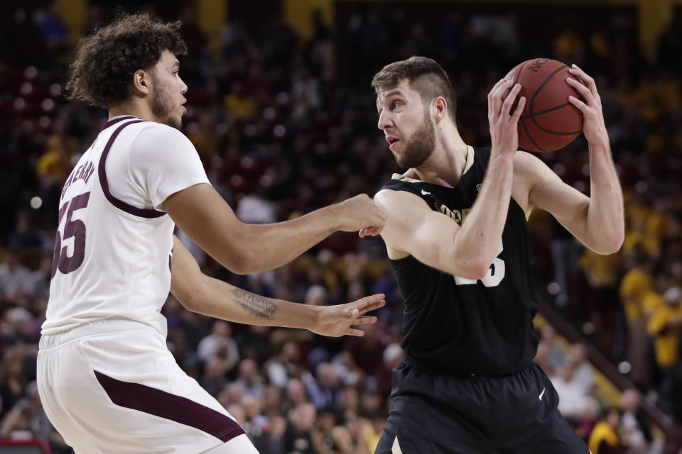 Colorado forward Lucas Stewart, right, looks to pass around Arizona State forward Taeshon Cherry during the first half of an NCAA college basketball game, Thursday, Jan. 16, 2020, in Tempe, Ariz. (AP Photo/Matt York)